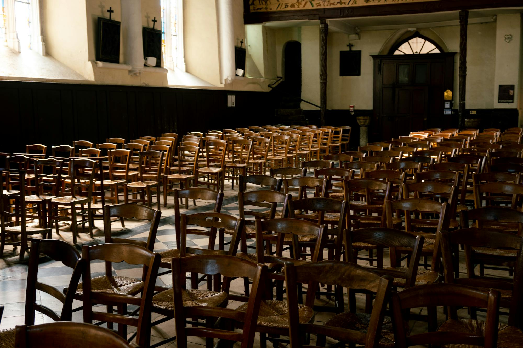 Empty church interior with wooden chairs and natural light