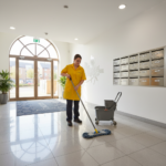 Professional cleaner mopping a clean communal hallway in a Bristol residential block